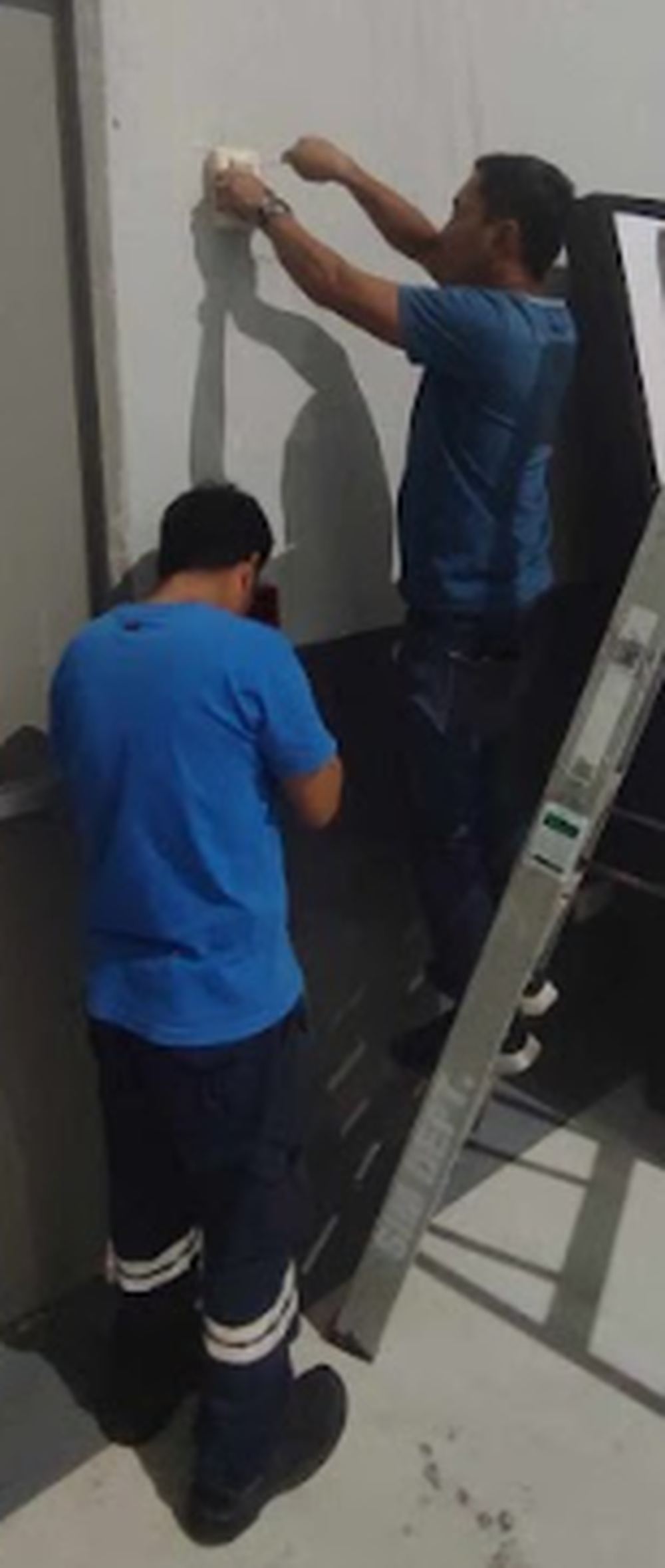 Two-person ceiling installation team